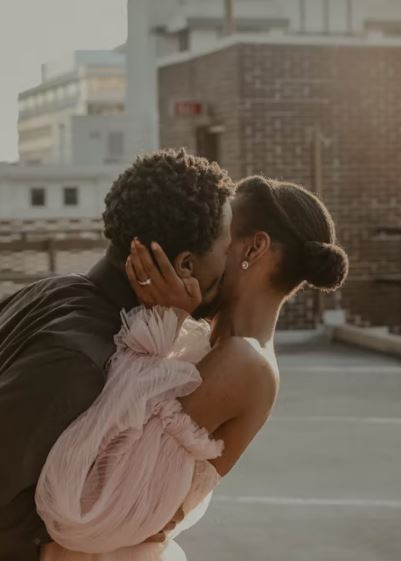 Romantic rooftop moment between a couple in elegant attire